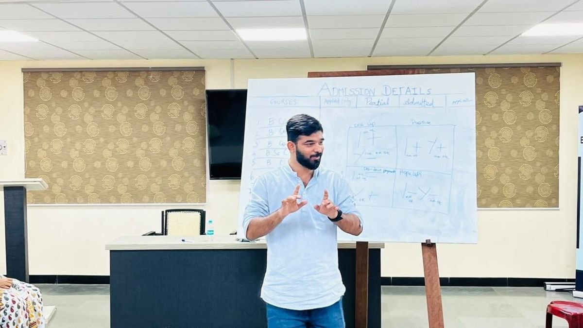 Chakkaravarthy RK speaking at a whiteboard during a session with college staff
